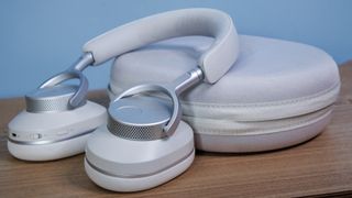 Cambridge Audio Melomania P100 SE headphones and case on a table.