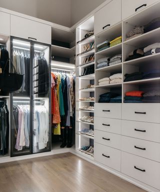 closet with white cabinetry, LED lights, hardwood floor, mixture of drawers, shelves