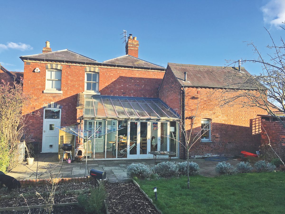 dated conservatory before shot on traditional brick Victorian house