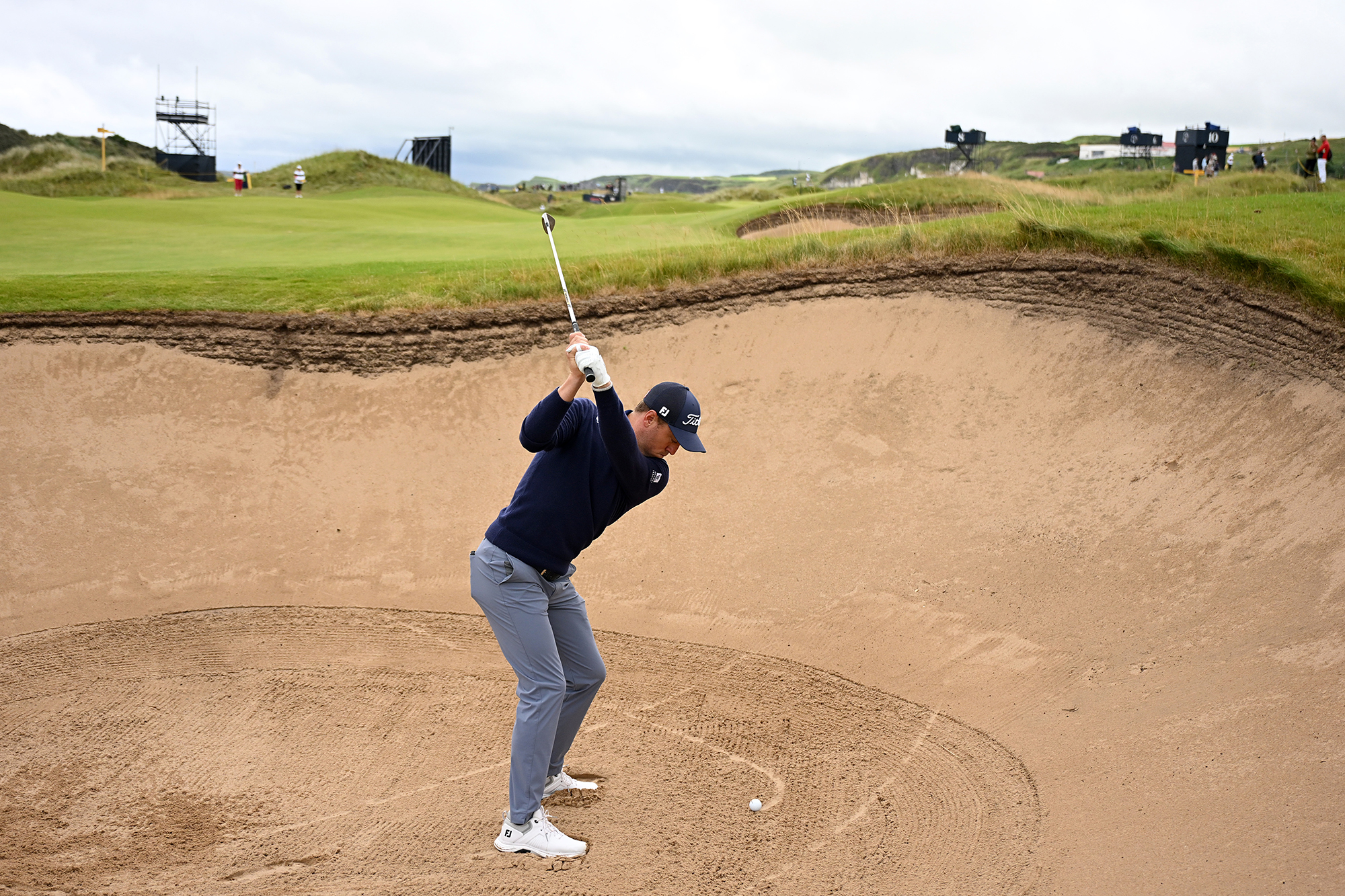 Justin Thomas playing a bunker shot at Royal Portrush in preparation for the 153rd Open Championship