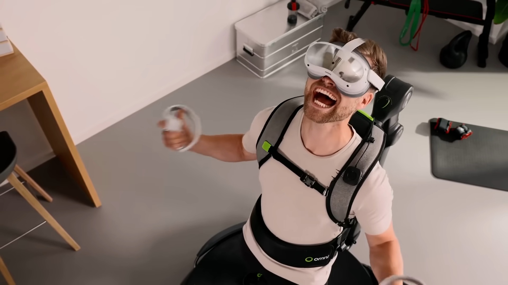 A VR user celebrating while using the Virtuix Omni One