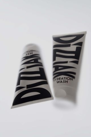 Dizziak haircare products in black and white packaging