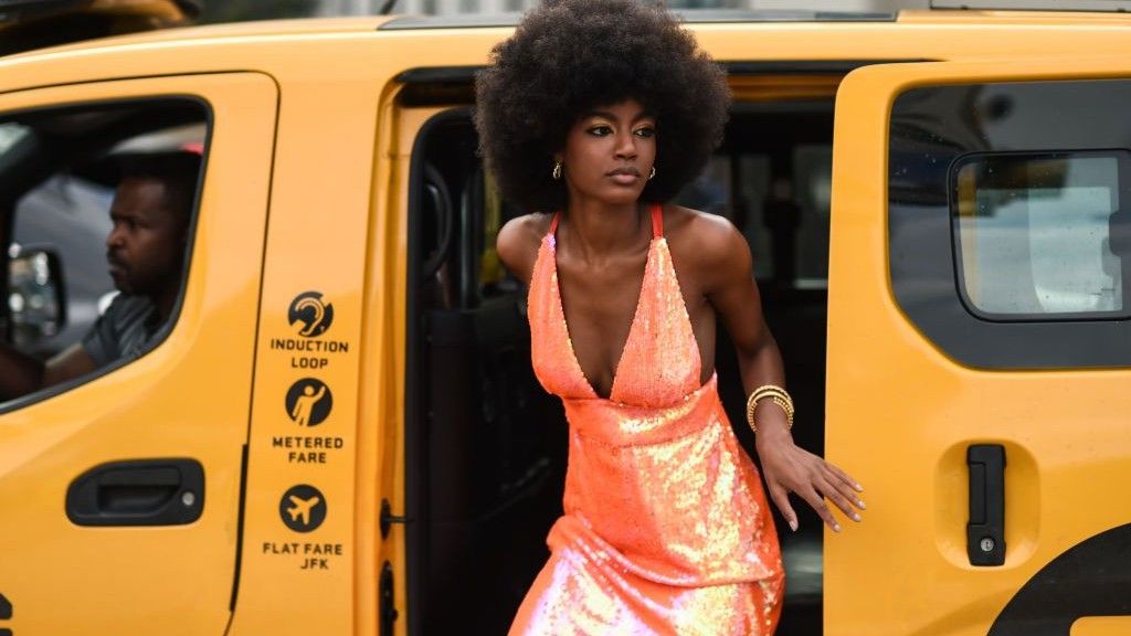 Woman in Sparkly Orange Halterneck Dress