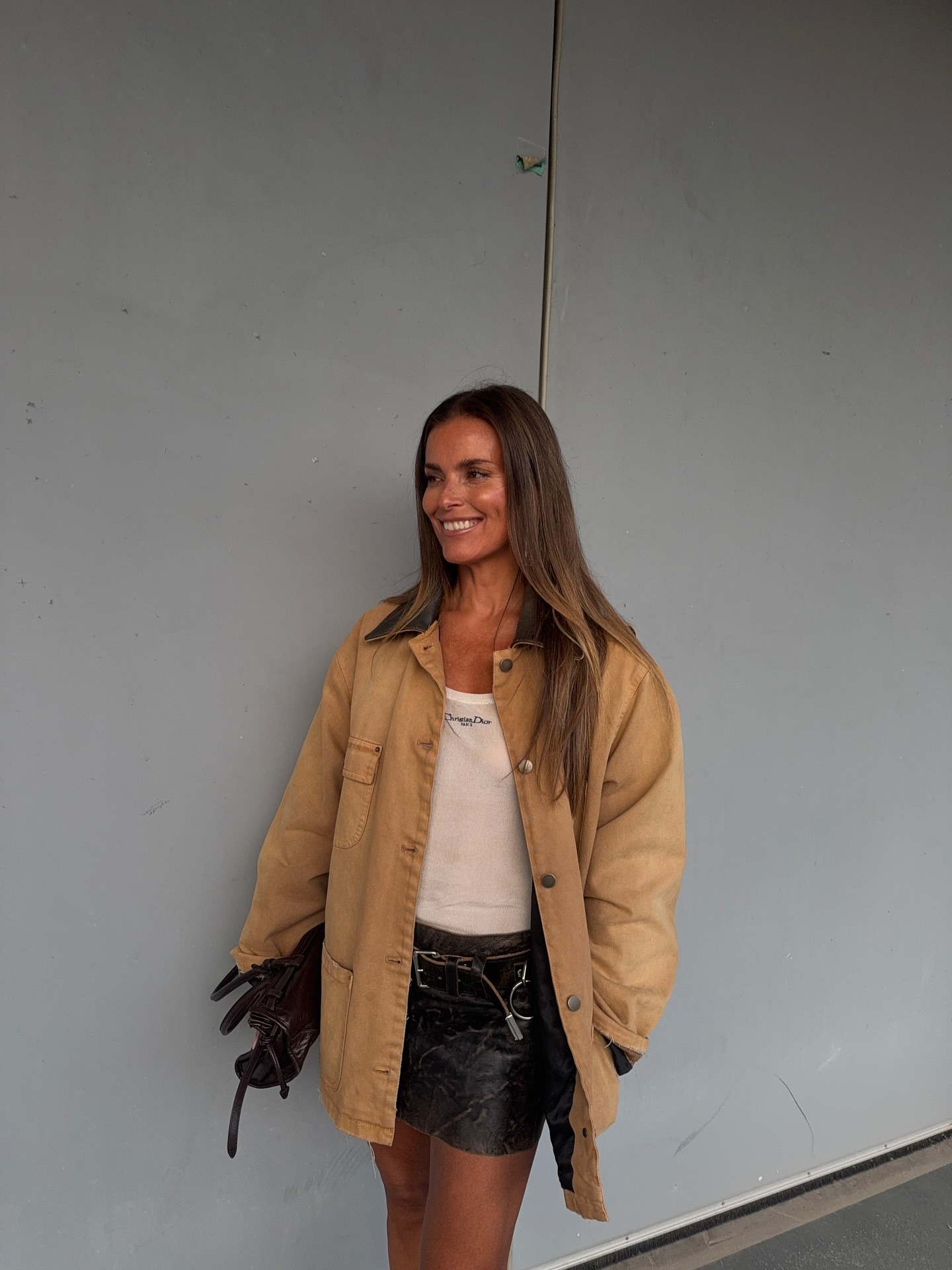 Woman in barn jacket and mini skirt