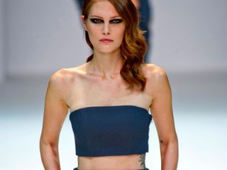 Catherine McNeil shows off her tattoos on the catwalk