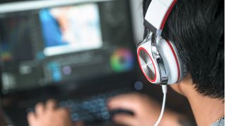 Best laptops for video editing - person with headphones at laptop