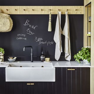 Blackboard wall next to sink in kitchen