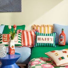 Green and blue sofa with stripe cushions