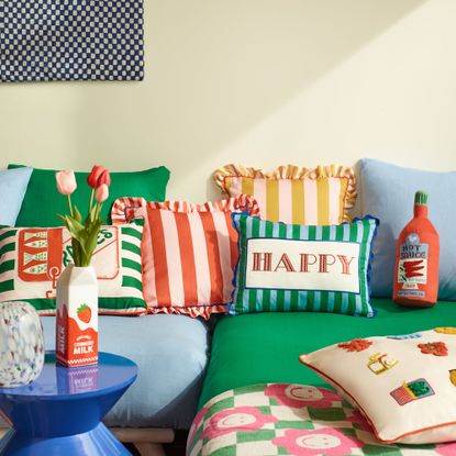 Green and blue sofa with stripe cushions