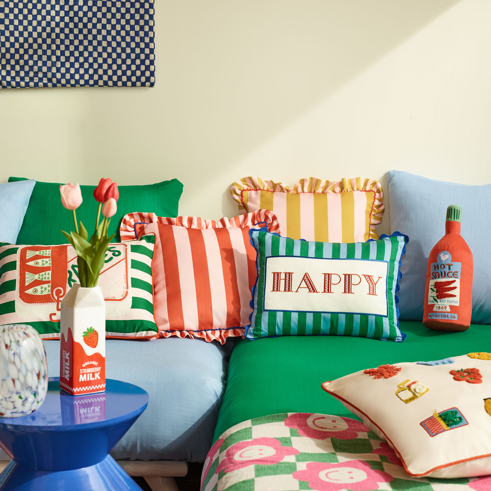 Green and blue sofa with stripe cushions