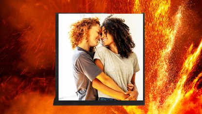 women embracing with backdrop of fire