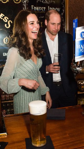 Prince William and Kate Middleton pull pints in a pub