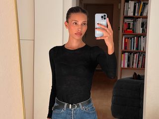 Tylynn Nguyen in a black T-shirt and dark wash jeans.