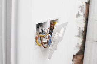 wires behind an electrical wall socket