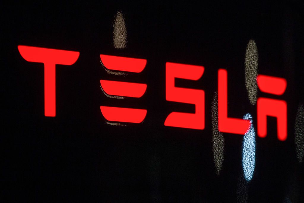 Red tesla logo on black background