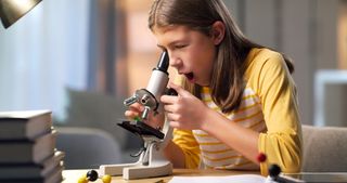 girl using a microscope