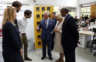 Prince Charles, Prince of Wales and Camilla, Duchess of Cornwall talk with European chief of IRC, Sanj Srikanthan (R), Nele Kapretz (L), the managing director of Impact Hub, Leon Reiner (2L) and the director of jobs4refugees, Robert Barr (3-L)