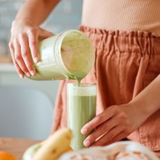 Self care ideas: A woman making a smoothie