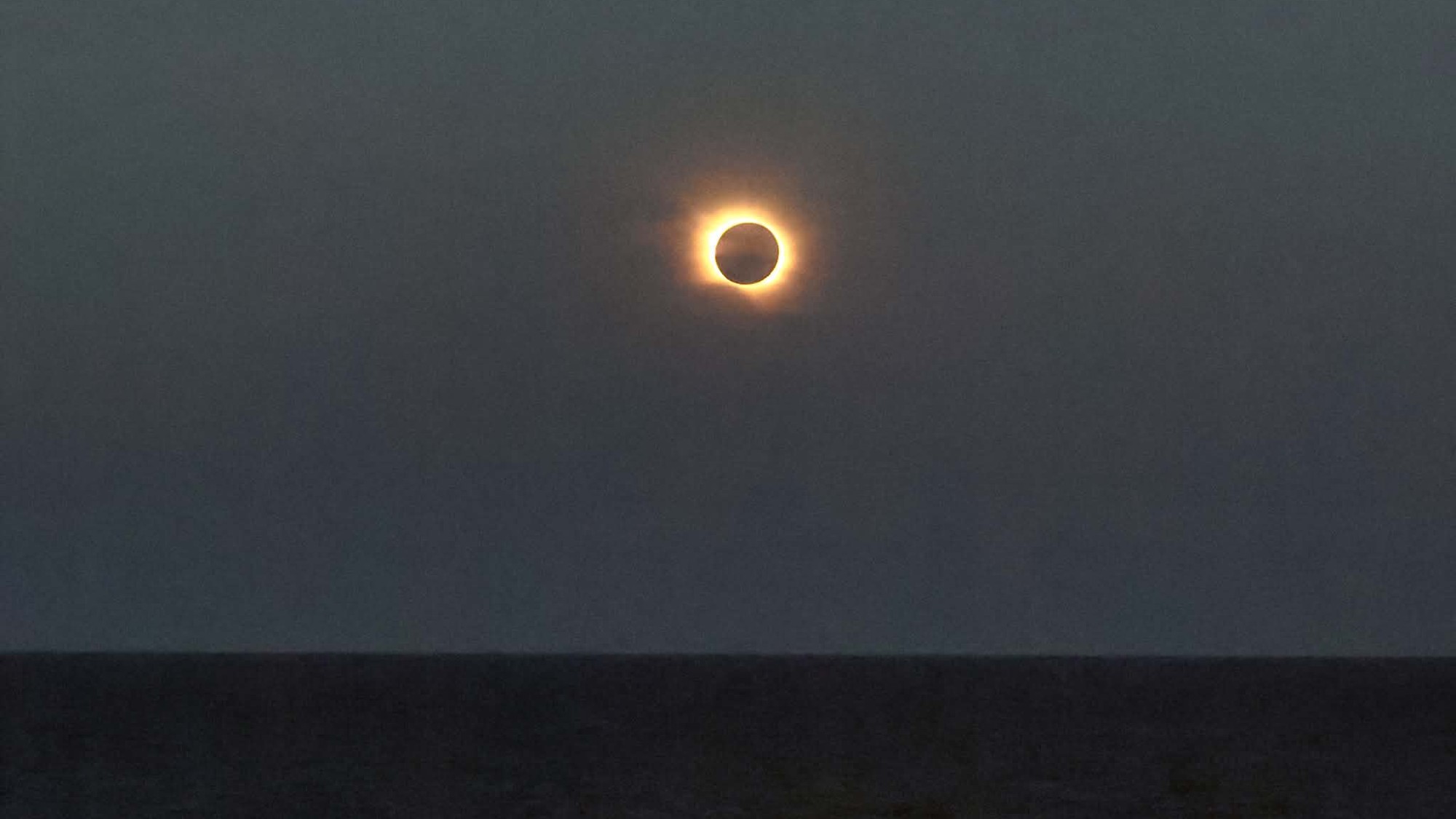 A weather satellite 22,000 miles above Earth saved my 2026 total solar eclipse cruise on the Mediterranean Sea 4 MyCelestialApp people sit on the deck of a ship wearing paper sunglasses, looking skyward