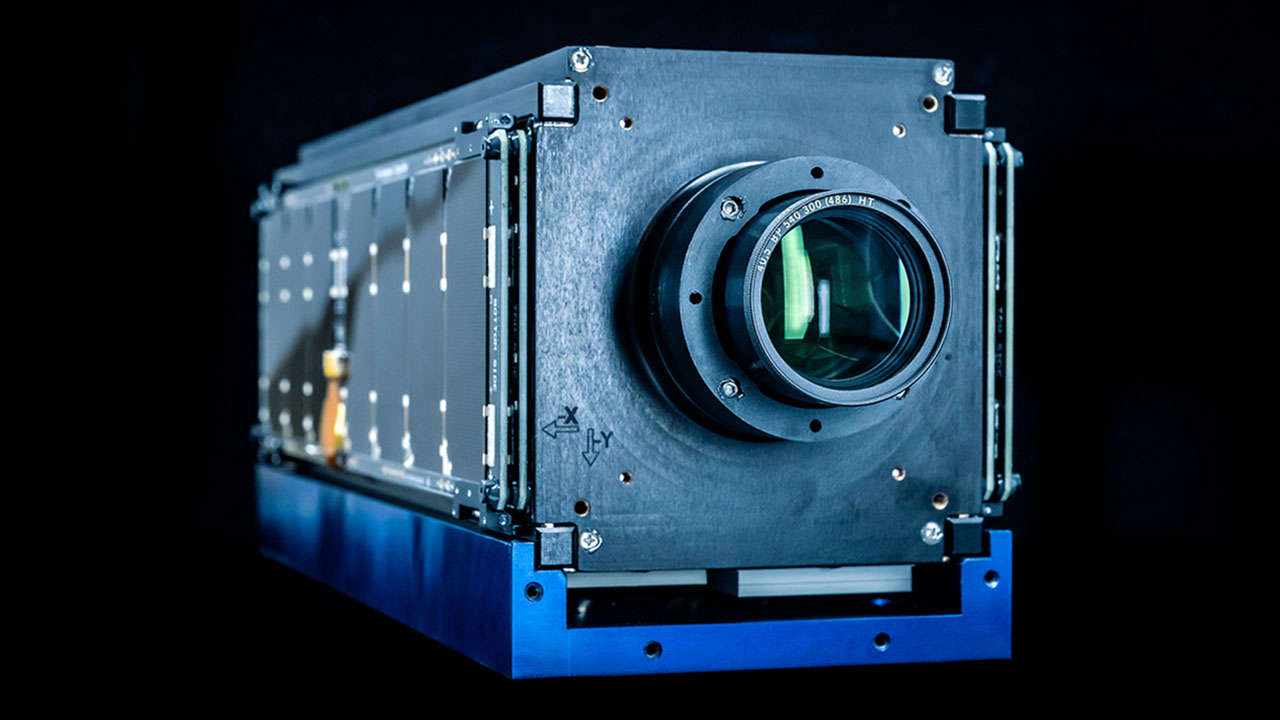 a shoebox-sized satellite with a camera on one end