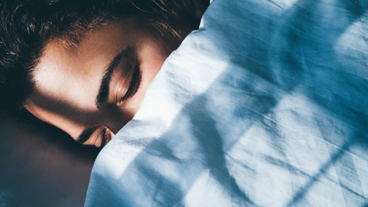 A woman sleeping using one of the best sleep tracking apps 