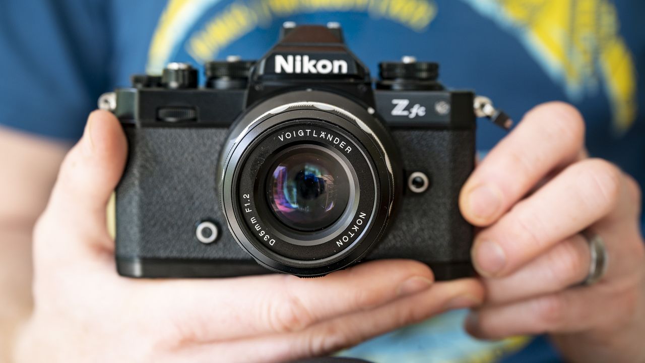 Voigtlander D 35mm f1.2 Nokton lens in the hand on a Nikon Z fc