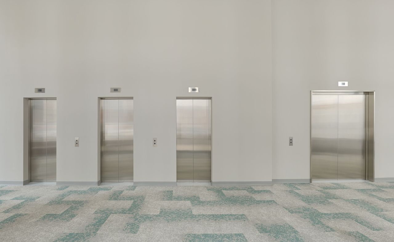 ‘Avery Singer: Free Fall’ at Hauser &amp; Wirth, London: a lobby-like corporate set with row of lifts