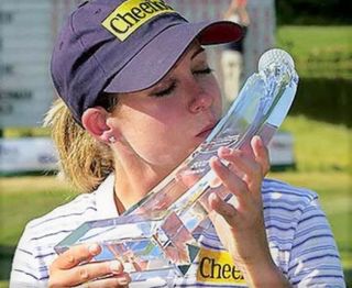 Kissing a golf trophy