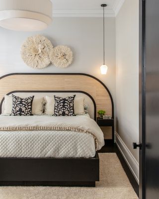 A small bedroom with an earthy headboard