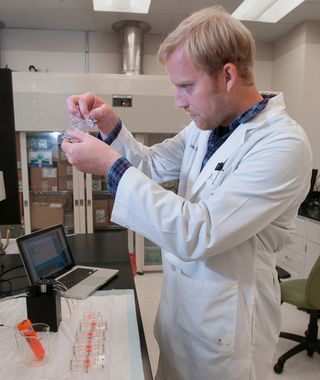 Aleks Skardal, post-doctoral fellow, assembles part of the "body on a chip" system.