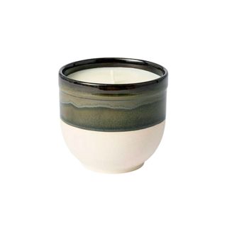 A candle with ceramic pot