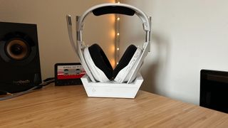Astro A50 X in charging cradle on a wooden desk