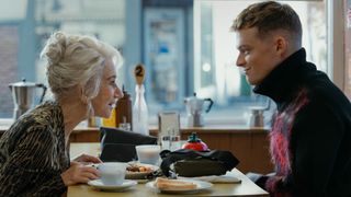 Maeve and Eddie talk over a greasy spoon cafe breakfast