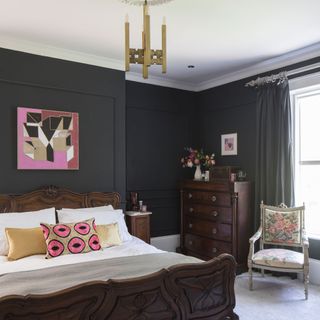 master bedroom with grey walls and wooden bed