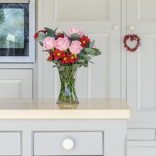 A vase of fresh flowers on a kitchen counter