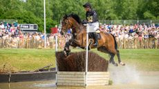 Christoph Wahler and D&rsquo;Accord jump a fence in the water at Badminton Horse Trials 2025.