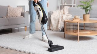 Woman vacuum cleaning carpet