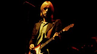 American Rock and Pop musician Tom Petty (1950 - 2017) plays guitar as he perfroms, with his band the Heartbreakers, during the 'Damn the Torpedoes' tour at the Capitol Theatre, Passaic, New Jersey, June 27, 1980