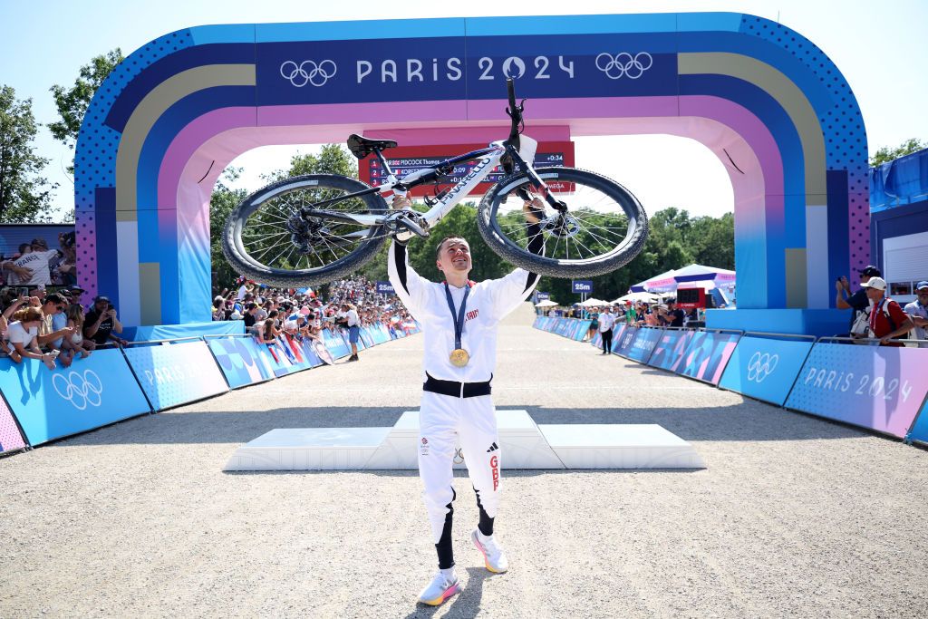 ELANCOURT FRANCE JULY 29 Gold medalist Thomas Pidcock of Team Great Britain holds his bike after the Mens CrossCountry on day three of the Olympic Games Paris 2024 at Elancourt Hill on July 29 2024 in Elancourt France Photo by Jared C TiltonGetty Images