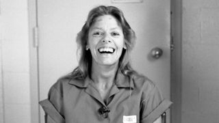 Promotional image of Aileen: Queen of the Serial Killers in black and white while laughing
