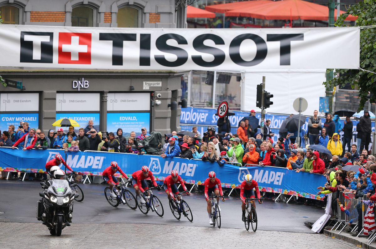 The Norway team riding in formation through the heart of Bergen