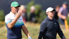 Padraig Harrington and Rory McIlroy (right) walk along at The Open Championship in 2024