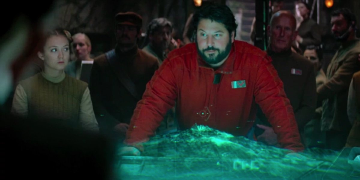 Star Wars: The Force Awakens Snap Wexley briefs the crowd over a holographic map