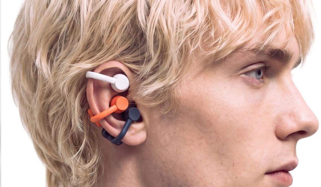 CMF Clip Pro wireless earbuds in various colours being worn by a man