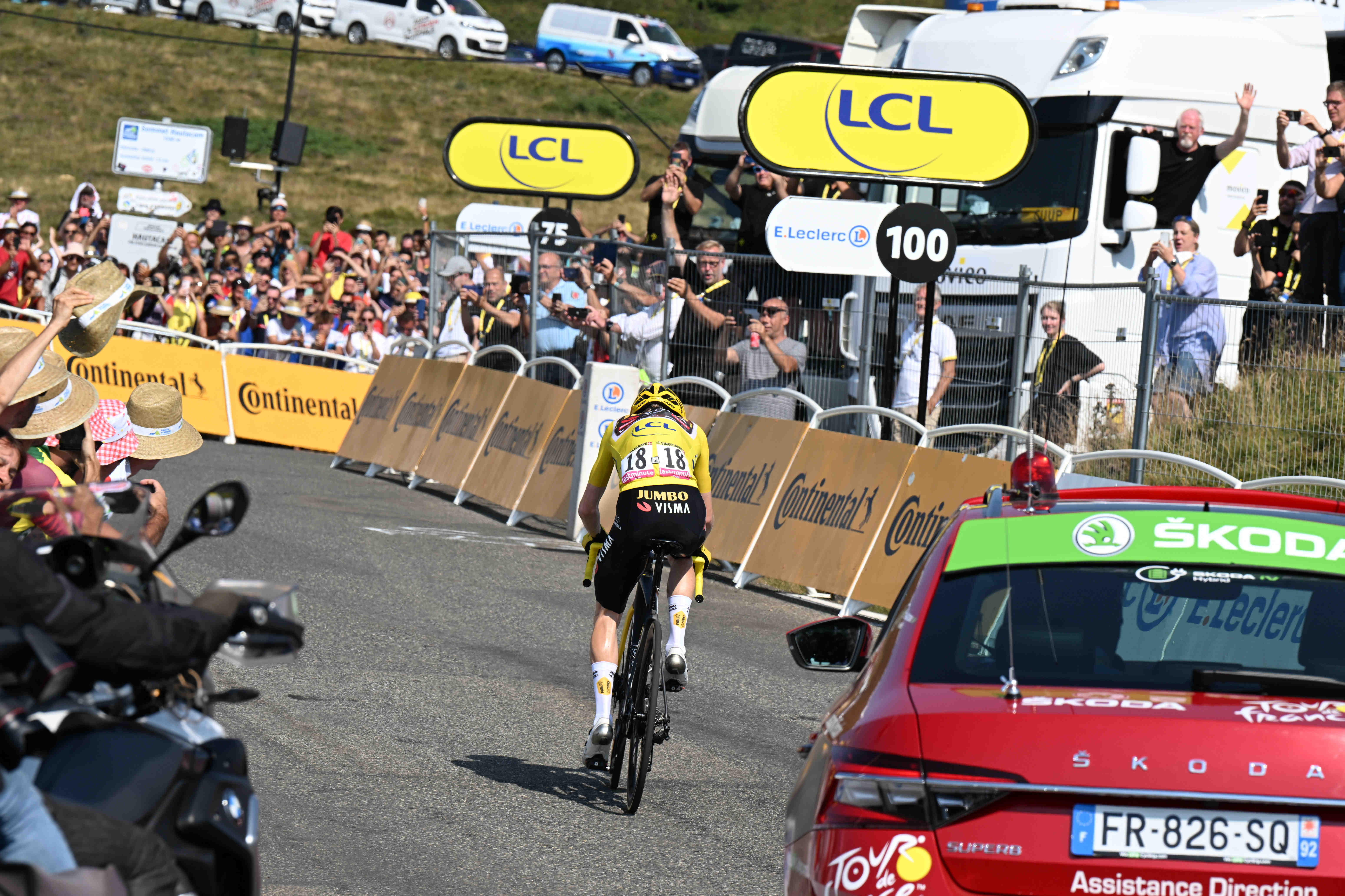 A photo from the 2022 Tour de France of cyclist Jonas Vingegaard, wearing the yellow jersey of the race leader, as he attacks a climb on the Hautacam stage. He is riding for the Jumbo-Visma team.
