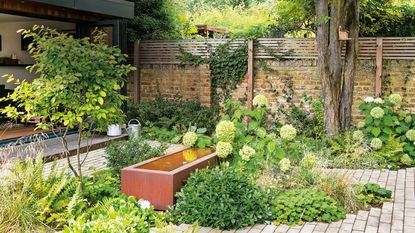 small garden water feature ideas: corten steel design with hydrangeas