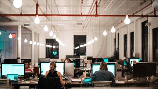 Workers in office at open plan desks