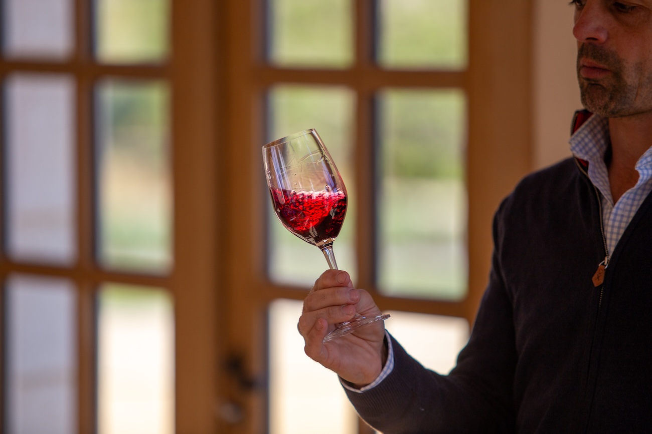 winemaker swirling red wine in glass