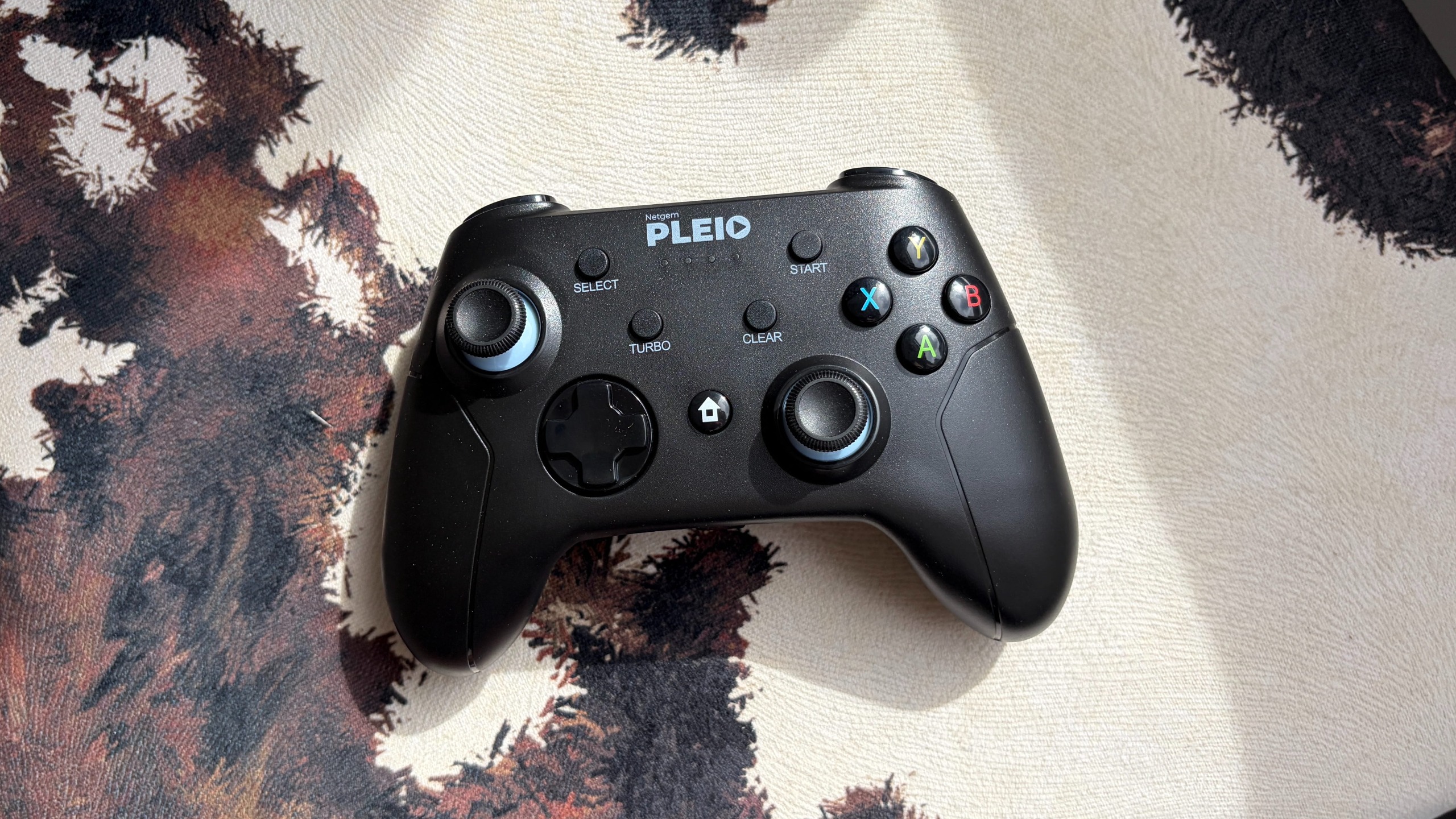 A games controller resting on a cowprint surface