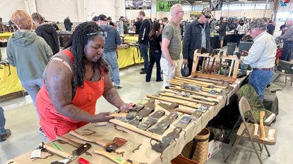 People shop at a prepper expo in Longmont, Colorado